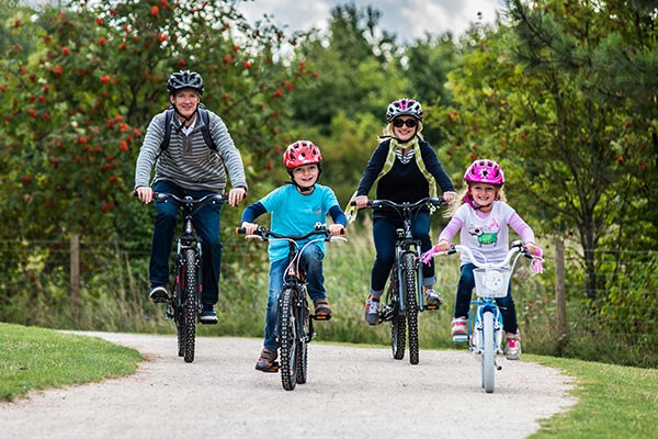 Family on bike ride in park